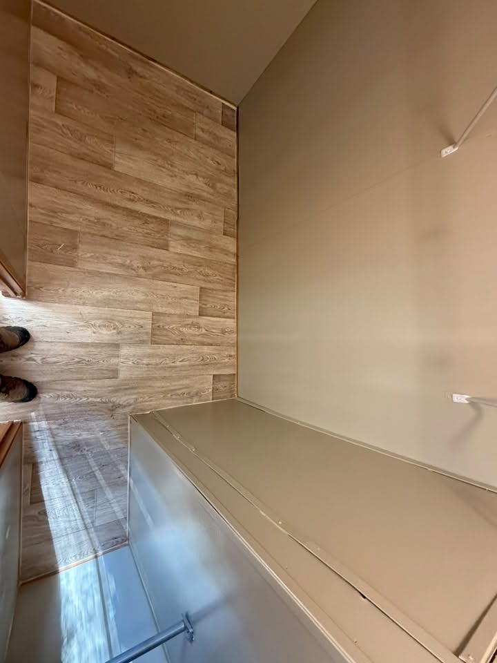 Newly installed wood-look flooring in a closet during a home remodel
